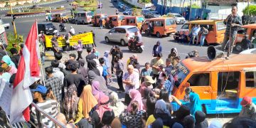 Puluhan warga yang tergabung dalam Aliansi Masyarakat Bandar Lampung Bersatu (AMBLB) menggelar aksi damai di depan kantor Pemerintah Kota Bandar Lampung